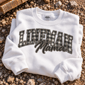 Lineman Mama sweatshirt with buffalo plaid lettering on a white crewneck