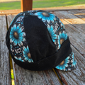 Handmade turquoise daisy reversible welding cap with BCT logo and black panels